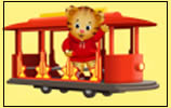 Animated tiger cub wearing a red hoodie waves while riding on a red trolley against a yellow background.