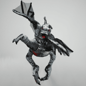 A plush dragon toy with gray, scaly-patterned fabric, red eyes, a red tongue, black wings, and four raised legs poses against a plain light background.